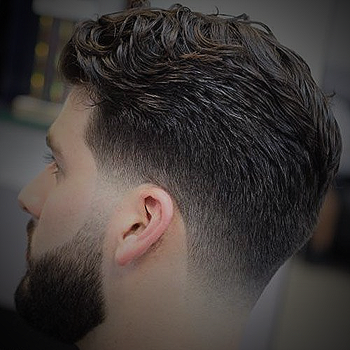 A man with a 3 on the sides taper fade
