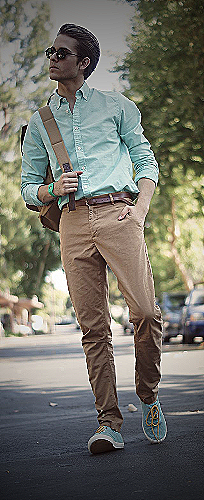 A man in a mint green shirt and brown pants