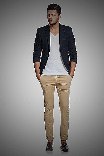 A model wearing a black blazer paired with beige khakis