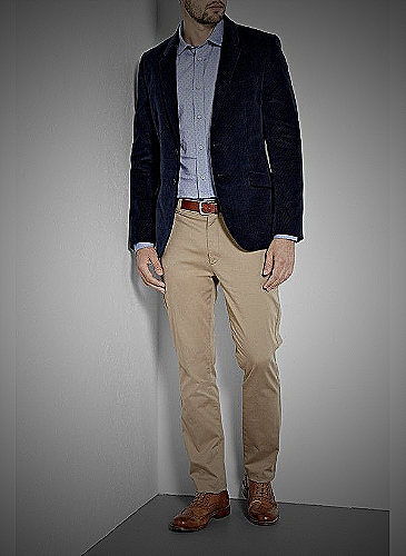 A model wearing a black blazer paired with navy khaki pants