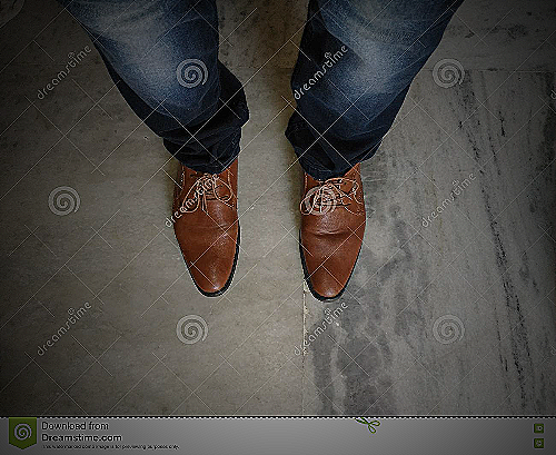 Blue jeans and brown shoes