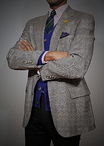 man wearing sport coat, navy pants, and earth-toned accessories
