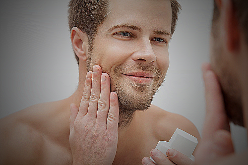 A man applying skincare products