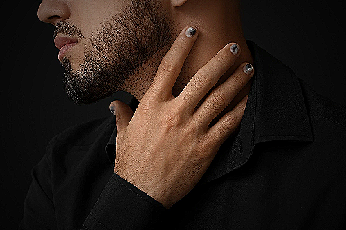 A man showing off his black nails as part of his fashion style