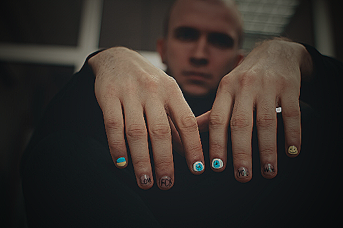 A man showing his support for cancer awareness by painting his nails black