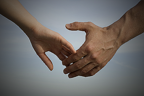 Image of a man and woman holding hands