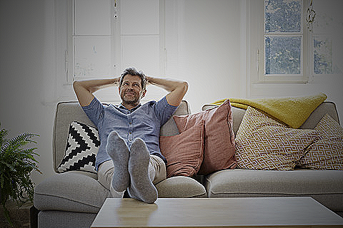 Image of a man sitting on the couch
