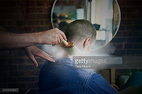 Man getting haircut at a barber shop - how often should you get a haircut men