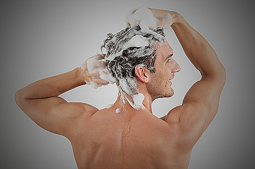 Man washing his hair with shampoo - how to wash hair men