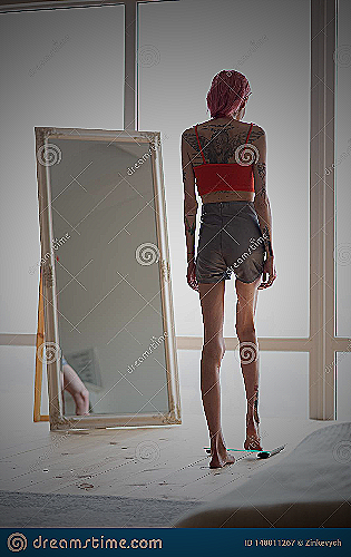 Skinny woman standing on a weighing scale