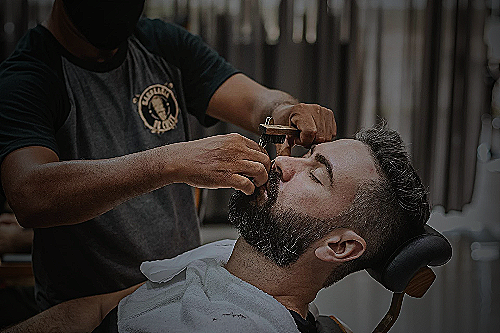 Man getting a haircut with a barber - how much to tip for mens haircut